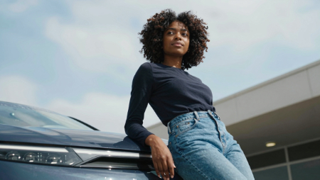 black woman with afro leaning against her new car generated with Z-Image