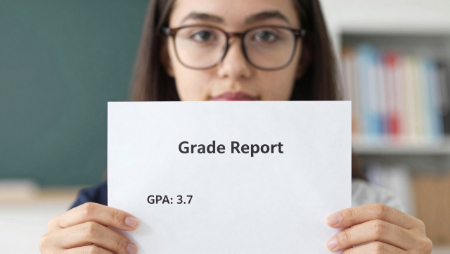student holding her grade report