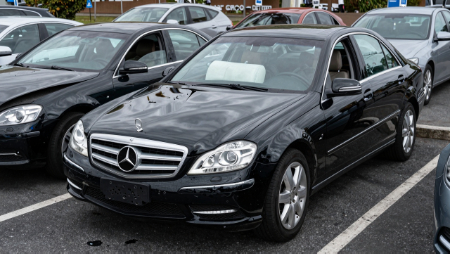 wrecked black car with deployed airbag in parking lot generated with Z-Image